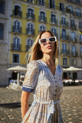 a lady wears a map printed midi dress with sunglasses